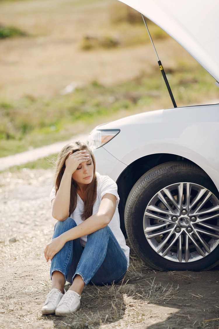 Woman near broken car calling for help